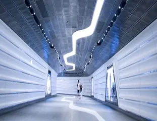 Two figures far down the white concourse of Seraph Station, a neon ribbon zig-zagging across its dark ceiling.